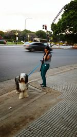 Rear view of woman standing on road