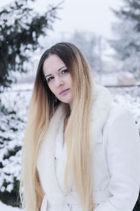 Portrait of woman against snow during winter