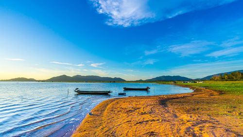 Scenic view of lake against blue sky