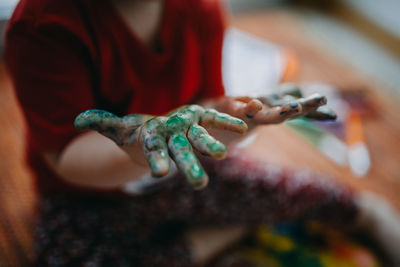 Close-up of child painted hands