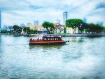 Boat sailing in river against sky