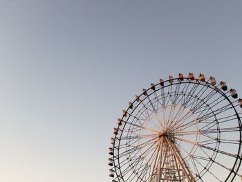 Low angle view of ferris wheel against clear sky