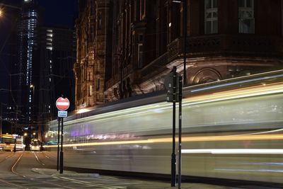 Blurred motion of cable car in city at night