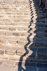 Great wall of china. morning. shadow of wall and railing on steps.