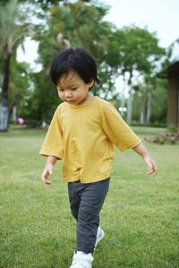 Side view of boy standing on field