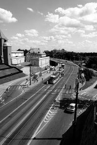 View of city street against cloudy sky