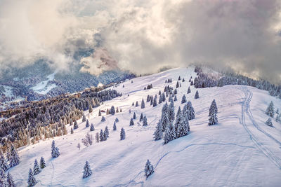 Scenic view of snow covered mountains against sky