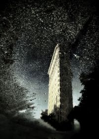 Reflection of building in puddle