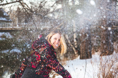 Portrait of a smiling woman in snow