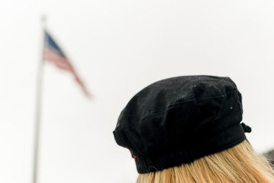 Rear view of person wearing hat against white background