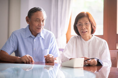 Senior couple sitting on table