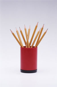 Close-up of red pencils on white background