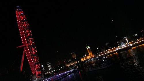 Illuminated city against sky at night