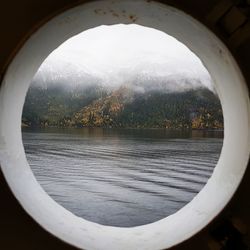 Scenic view of lake seen through window