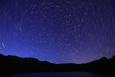 Scenic view of lake against star field at night