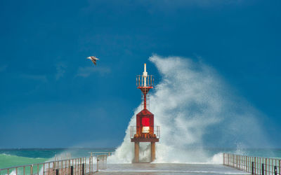 Wave breaking on the lighthouse.