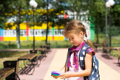 Girl looking at camera while standing outdoors