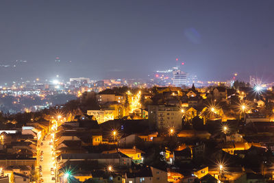 High angle view of illuminated buildings against sky