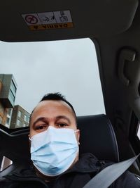 Portrait of man sitting in car