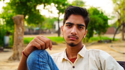 Portrait of young man sitting outdoors