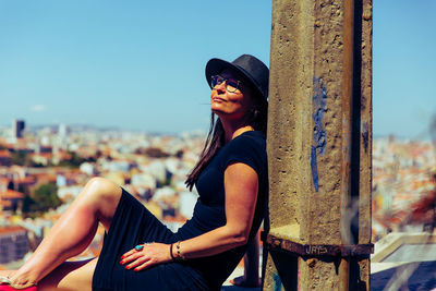 Portrait of young woman sitting outdoors