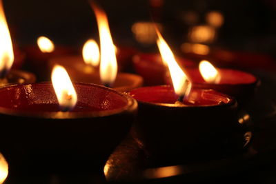Close-up of lit tea light candles in temple