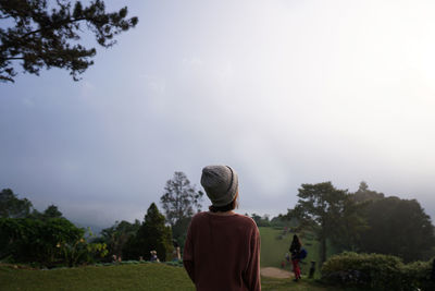 Rear view of women against trees and sky