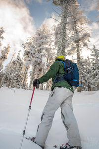 Man skiing on snow covered land