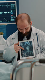 Doctor showing digital tablet in hospital