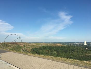 Scenic view of landscape against blue sky