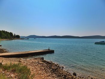 Scenic view of sea against clear blue sky