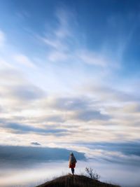 Silhouette of people against cloudy sky