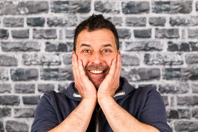 Portrait of smiling man against wall