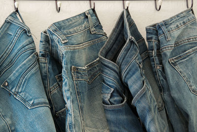 Close-up of jeans hanging from rack