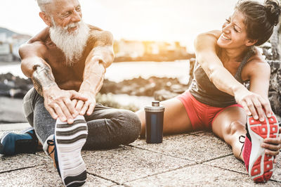 Smiling friends exercising at beach