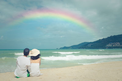 Rear view of couple standing on beach