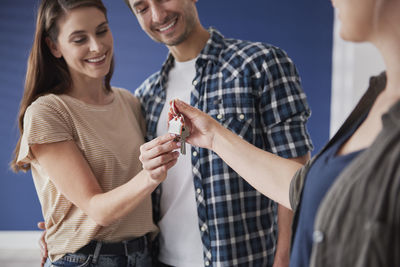 Midsection of a smiling young woman holding hands