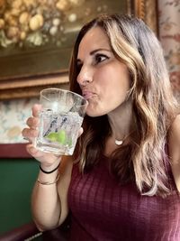 Portrait of woman drinking glass