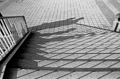 High angle view of shadows on steps at footpath