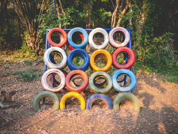 Stack of multi colored tyre on field