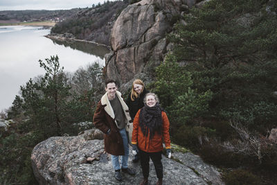 Rear view of people standing on rock