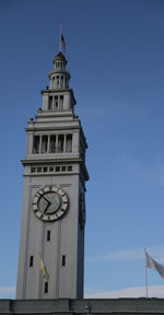 Low angle view of clock tower against sky