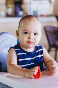 Portrait of cute baby sitting on table