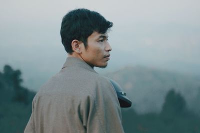 Portrait of young man looking away