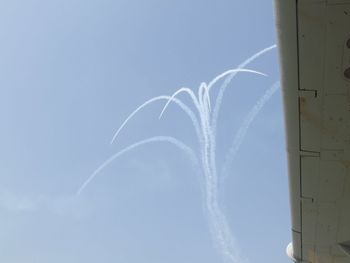 Low angle view of vapor trails in sky