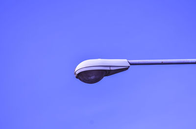 Low angle view of street light against clear blue sky