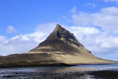 Scenic view of sea and mountains against sky