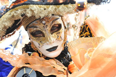 Close-up of person wearing venetian mask