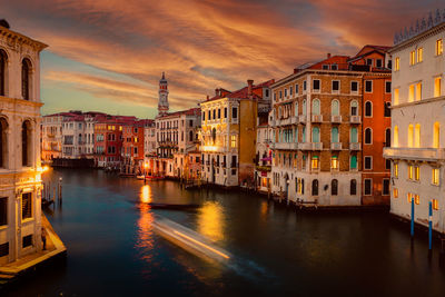 Buildings in city at sunset