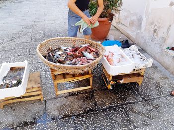 High angle view of man preparing fish on grill